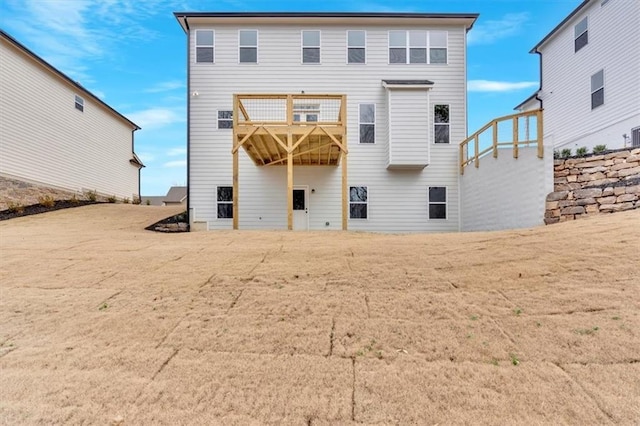 back of property with a balcony