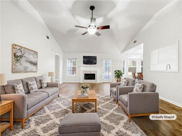 living room featuring ceiling fan, hardwood / wood-style floors, and high vaulted ceiling