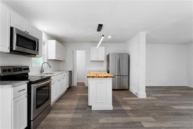15 Baker St, Cartersville, GA 30120 - kitchen with stainless steel appliances, butcher block counters, white cabinets, dark wood-type flooring, and a center island