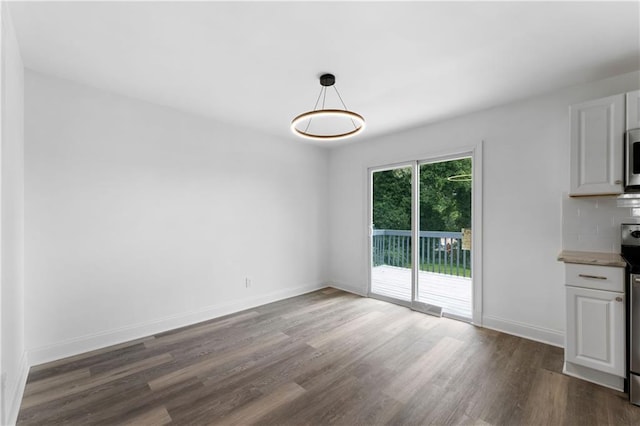 15 Baker St, Cartersville, GA 30120 - unfurnished dining area with dark wood-style floors and baseboards