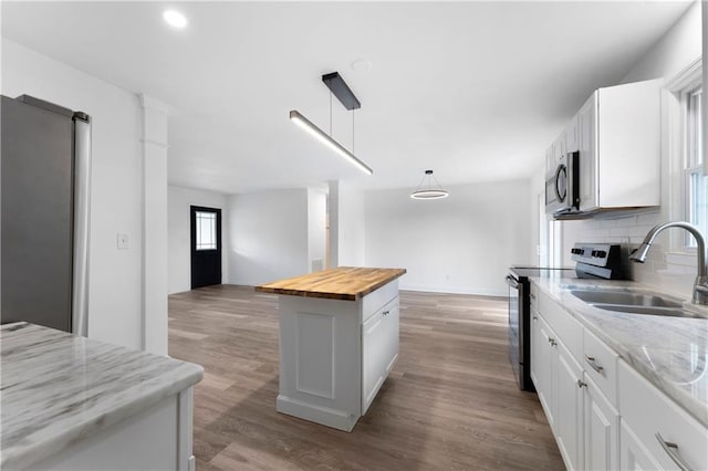15 Baker St, Cartersville, GA 30120 - kitchen with appliances with stainless steel finishes, wooden counters, white cabinets, tasteful backsplash, and recessed lighting