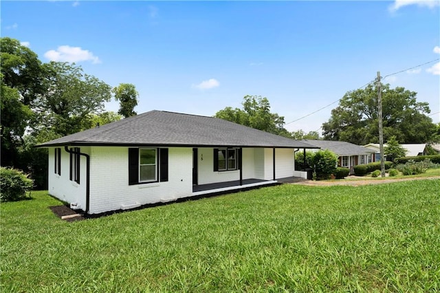 15 Baker St, Cartersville, GA 30120 - view of front of property with covered porch, a front lawn, brick siding, and roof with shingles