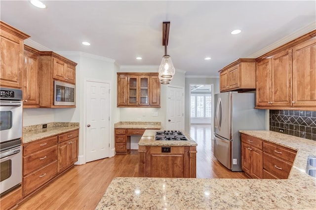 2748 Hidden Falls Dr, Buford, GA 30519 - kitchen with crown molding, stainless steel appliances, light wood-style floors, brown cabinets, and light stone counters