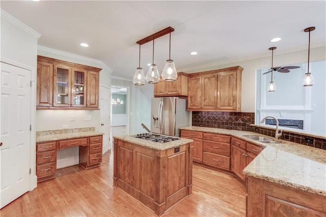 2748 Hidden Falls Dr, Buford, GA 30519 - kitchen with stainless steel appliances, ceiling fan, ornamental molding, light wood-style floors, and brown cabinetry