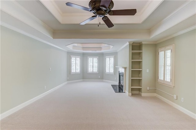 2748 Hidden Falls Dr, Buford, GA 30519 - unfurnished living room with a raised ceiling, light colored carpet, a high end fireplace, ornamental molding, and ceiling fan