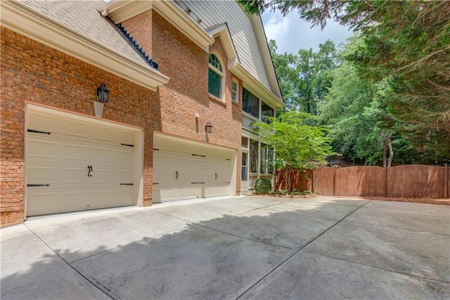 2748 Hidden Falls Dr, Buford, GA 30519 - view of side of property with driveway, brick siding, and an attached garage
