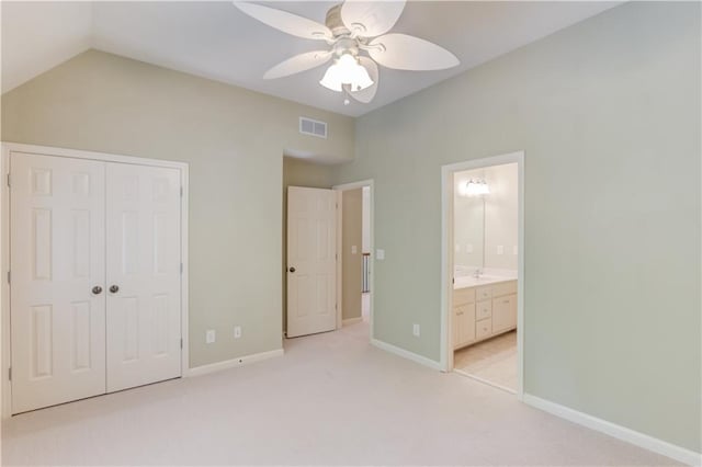 2748 Hidden Falls Dr, Buford, GA 30519 - unfurnished bedroom with a closet, vaulted ceiling, light carpet, connected bathroom, and ceiling fan