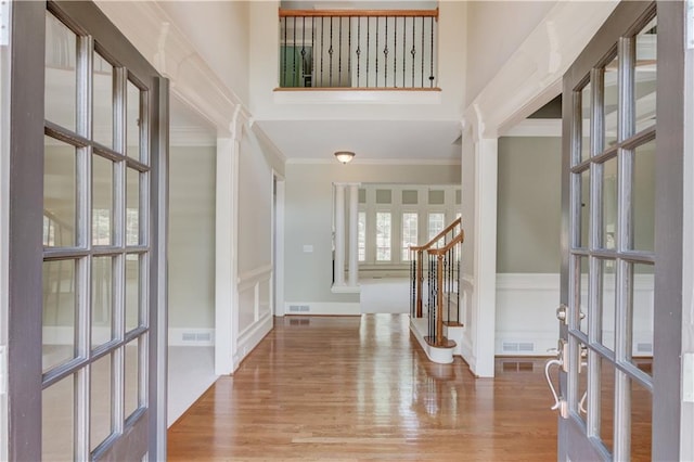 2748 Hidden Falls Dr, Buford, GA 30519 - foyer featuring ornamental molding, stairway, wood finished floors, a towering ceiling, and a decorative wall