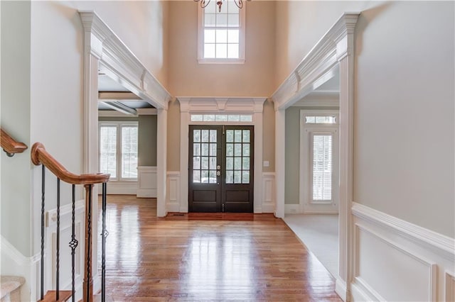 2748 Hidden Falls Dr, Buford, GA 30519 - entrance foyer with a decorative wall, a wainscoted wall, plenty of natural light, a chandelier, and wood finished floors