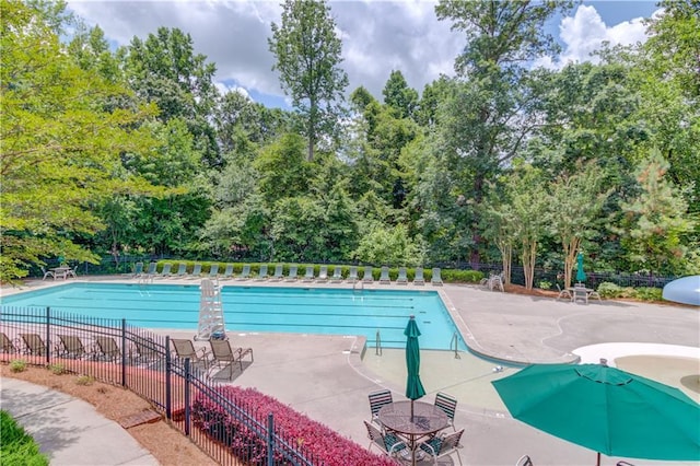 2748 Hidden Falls Dr, Buford, GA 30519 - community pool with view of wooded area and a patio area