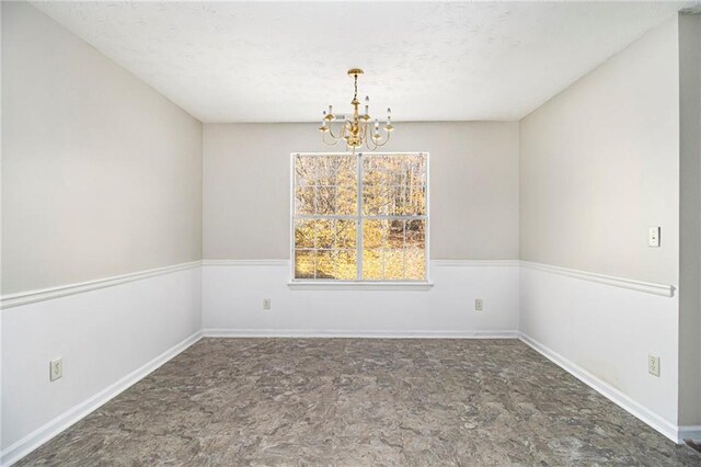 empty room with an inviting chandelier