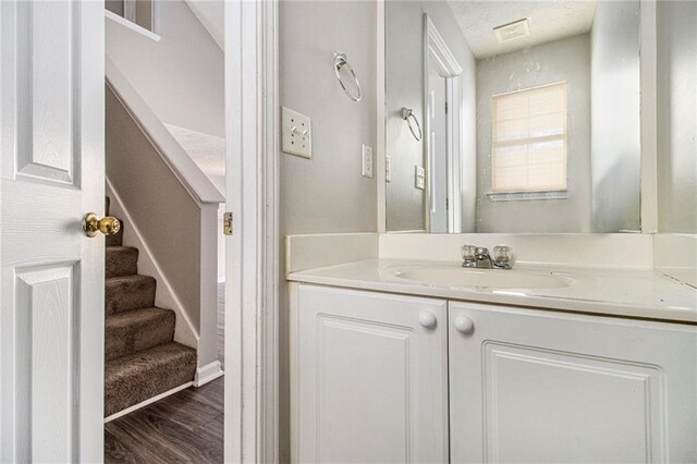 bathroom with hardwood / wood-style floors and vanity