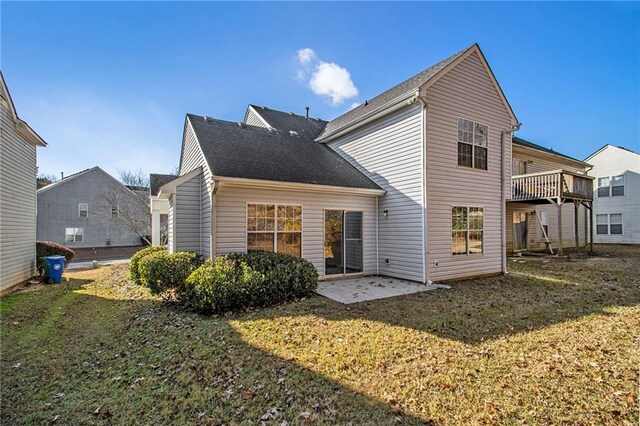 back of property with a patio area and a yard