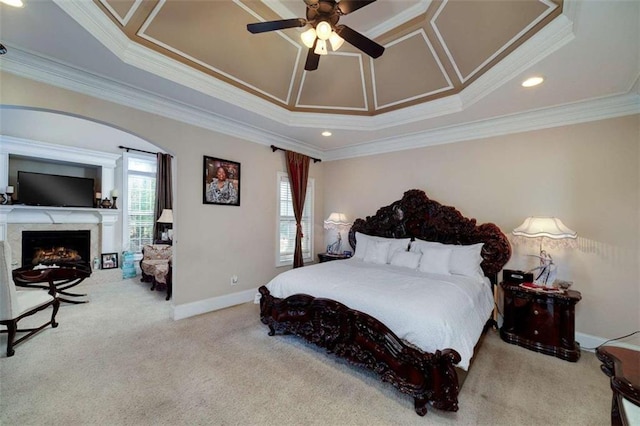 carpeted bedroom with a premium fireplace, baseboards, ornamental molding, and multiple windows