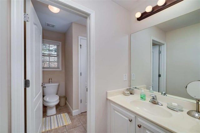 bathroom featuring toilet, vanity, visible vents, and tile patterned floors