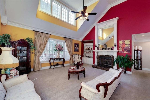 carpeted living area featuring crown molding, baseboards, a premium fireplace, a ceiling fan, and high vaulted ceiling