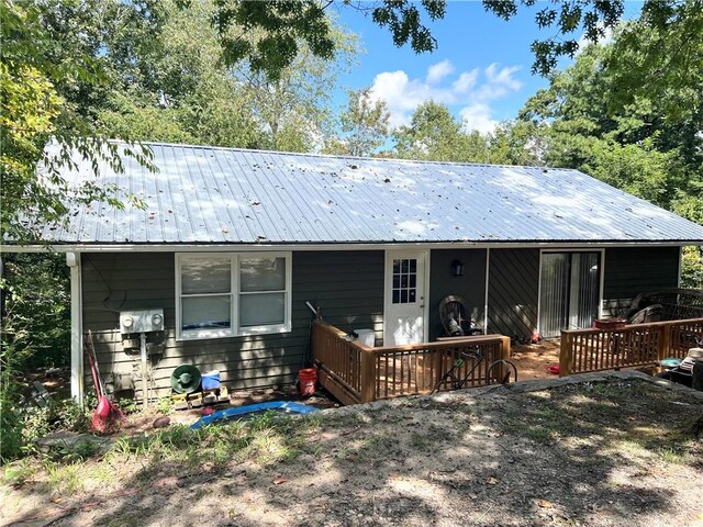 back of house with a wooden deck