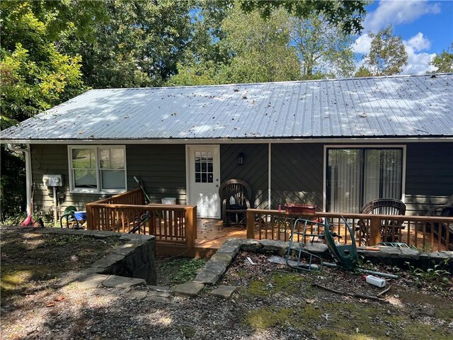 rear view of property featuring a deck