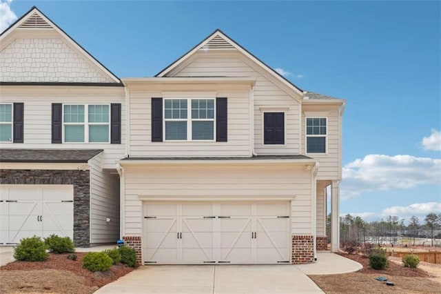 view of front of property featuring driveway, an attached garage, and brick siding