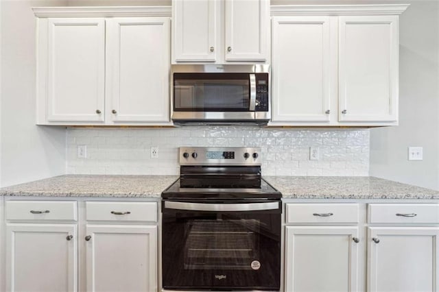 kitchen featuring appliances with stainless steel finishes, white cabinetry, and backsplash