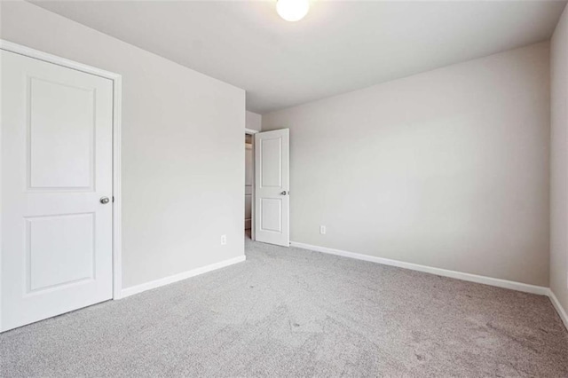 unfurnished bedroom featuring carpet floors and baseboards