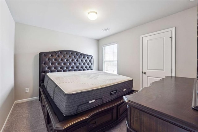 carpeted bedroom featuring visible vents and baseboards