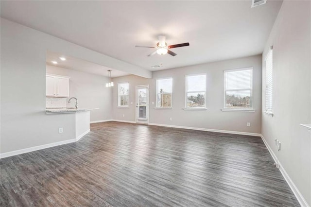 unfurnished living room featuring visible vents, baseboards, a ceiling fan, dark wood-style flooring, and recessed lighting