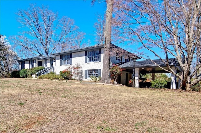 ranch-style house featuring brick siding and a front yard