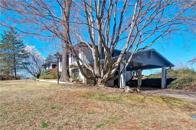 view of side of property featuring a yard and driveway