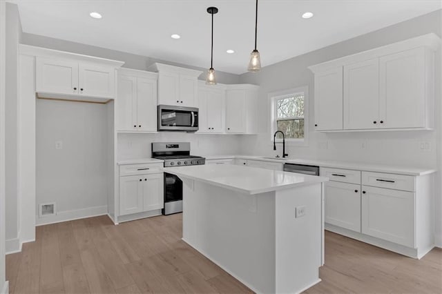 28 Creekview Dr SE, Cartersville, GA 30120 - kitchen featuring appliances with stainless steel finishes, a sink, white cabinetry, light wood finished floors, and recessed lighting