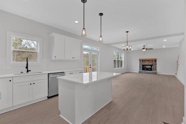 28 Creekview Dr SE, Cartersville, GA 30120 - kitchen featuring stainless steel dishwasher, a sink, light wood-style flooring, light countertops, and a kitchen island