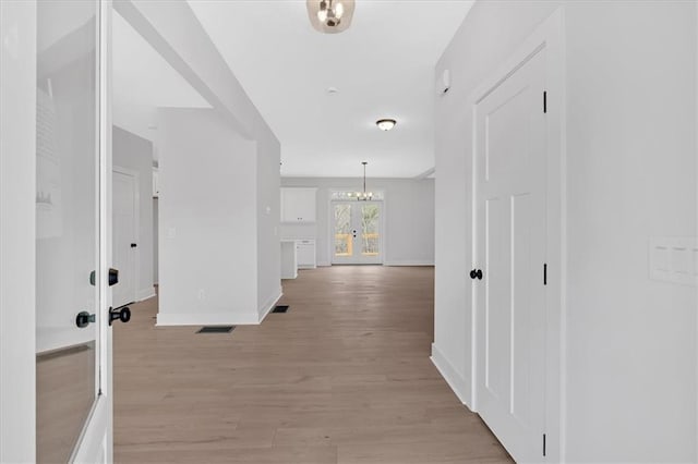 28 Creekview Dr SE, Cartersville, GA 30120 - corridor featuring french doors, baseboards, a chandelier, and light wood-style floors