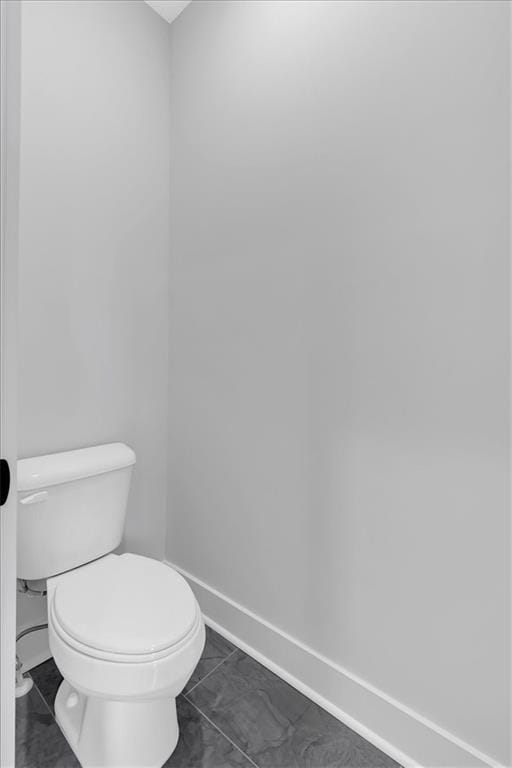 28 Creekview Dr SE, Cartersville, GA 30120 - bathroom featuring baseboards, marble look tiles, and toilet