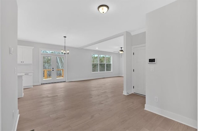 28 Creekview Dr SE, Cartersville, GA 30120 - unfurnished room featuring baseboards, light wood-style flooring, a chandelier, a ceiling fan, and french doors