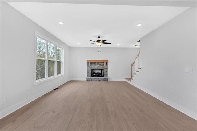 28 Creekview Dr SE, Cartersville, GA 30120 - unfurnished living room featuring ceiling fan, light wood-type flooring, baseboards, a stone fireplace, and recessed lighting