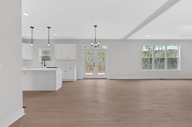 28 Creekview Dr SE, Cartersville, GA 30120 - unfurnished living room featuring a sink, recessed lighting, light wood-style flooring, a chandelier, and baseboards