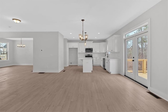 28 Creekview Dr SE, Cartersville, GA 30120 - kitchen with a chandelier, appliances with stainless steel finishes, open floor plan, french doors, and recessed lighting