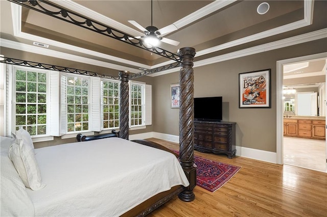 bedroom with a tray ceiling and crown molding