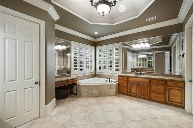 bathroom with vanity, visible vents, ornamental molding, a bath, and a tray ceiling