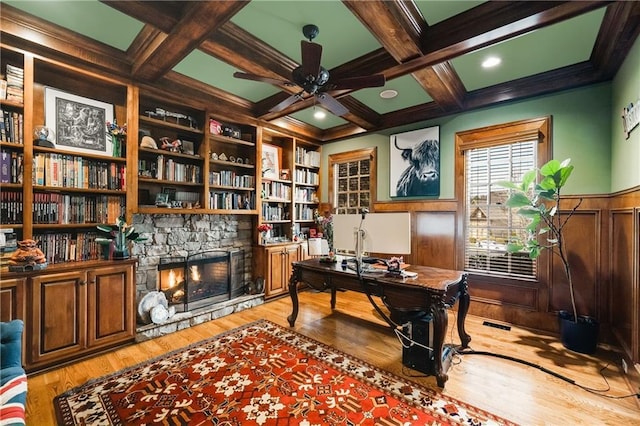 office space featuring a wainscoted wall, coffered ceiling, and beamed ceiling