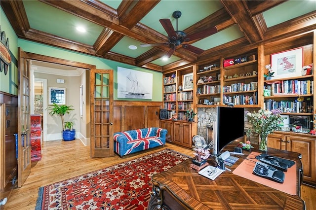 office with coffered ceiling, ceiling fan, ornamental molding, wood finished floors, and beamed ceiling