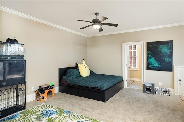 bedroom featuring baseboards, carpet flooring, a ceiling fan, and crown molding