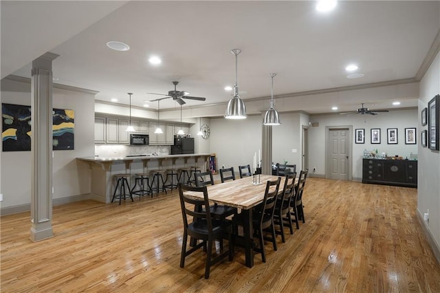 dining room featuring recessed lighting, crown molding, light wood-style flooring, and baseboards