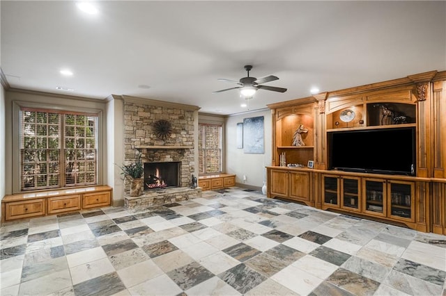 unfurnished living room with recessed lighting, a ceiling fan, crown molding, and a stone fireplace