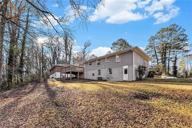 back of property featuring central AC unit and a wooden deck