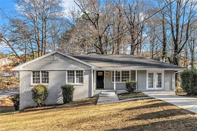 single story home featuring a front yard, french doors, and covered porch