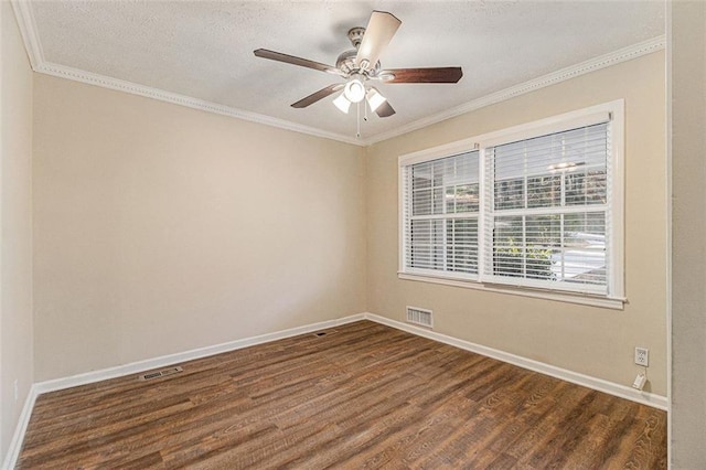 empty room with ceiling fan, dark wood-type flooring, and ornamental molding