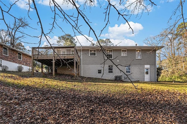 back of house with central air condition unit, a lawn, and a wooden deck