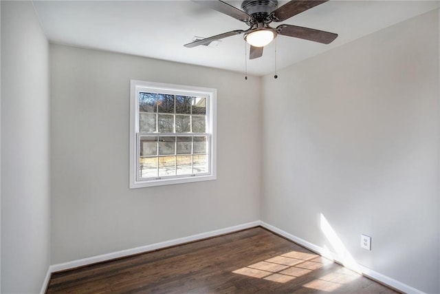 spare room featuring ceiling fan, baseboards, and wood finished floors