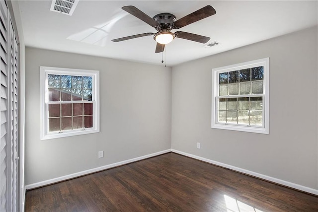 unfurnished room featuring ceiling fan, wood finished floors, visible vents, and baseboards